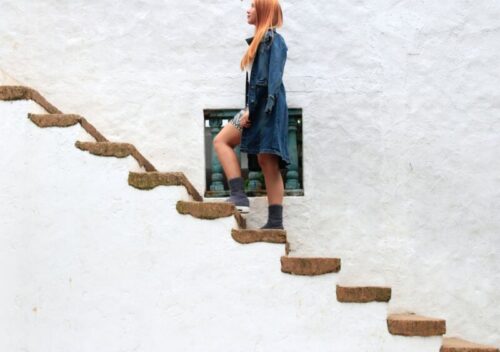 woman climbing on brown concrete stairs
