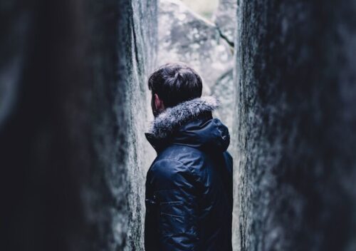 man standing on small pathway