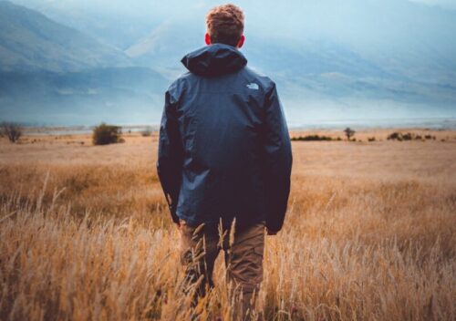 man in middle of wheat field