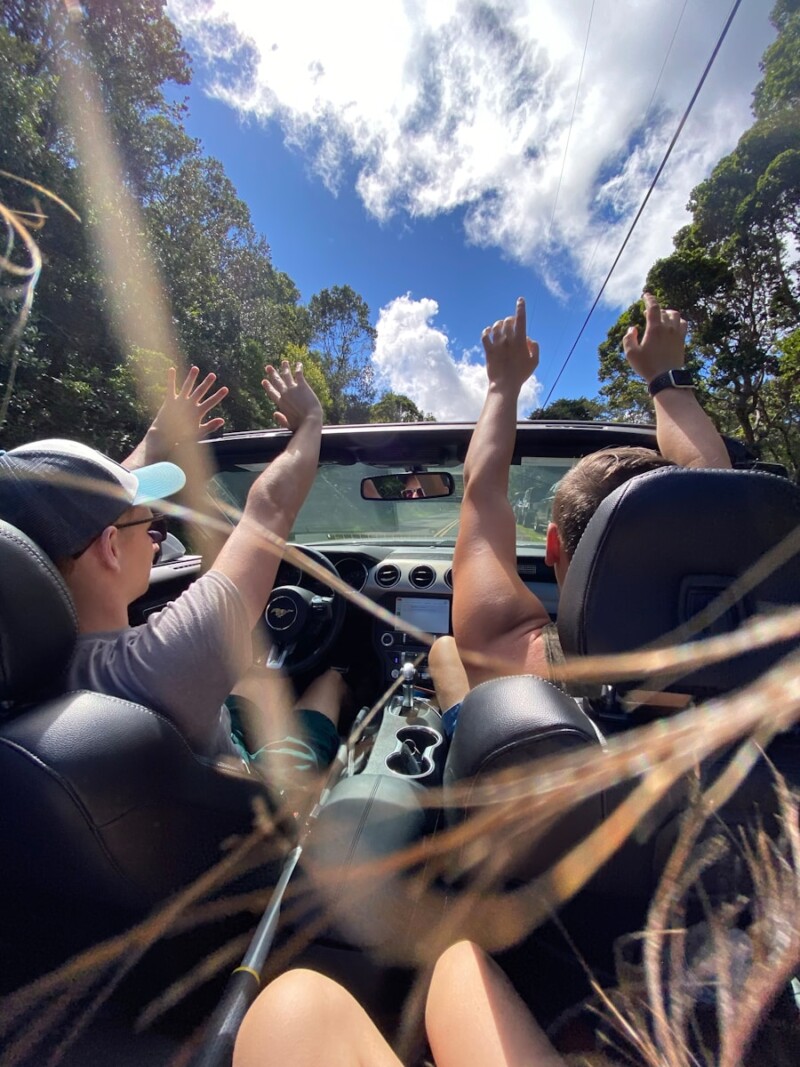 people riding on car during daytime
